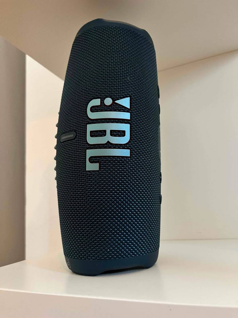Bluetooth-Lautsprecher im Test: Ein Bluetooth-Lautsprecher steht auf seiner kurzen Seite in einem hellen Regal