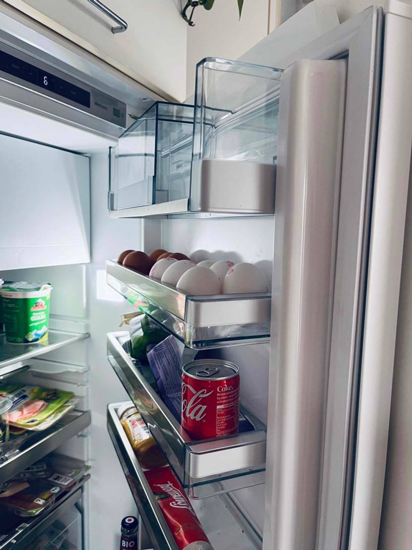 Ein getesteter Einbaukühlschrank mit geöffneter Tür.