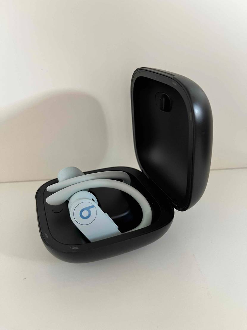 Sport-Kopfhörer getestet: ein Paar von Beats in einer schwarzen Aufbewahrungsbox seitlich betrachtet auf weißer Fläche.