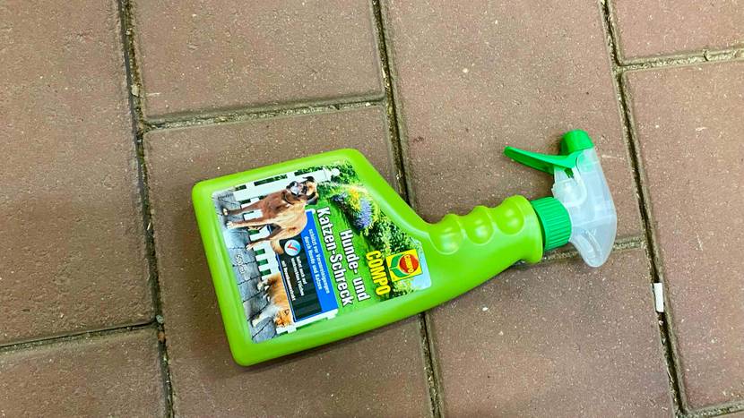Eine Flasche des getesteten Katzenschrecks liegt horizontal auf einem Steinboden.