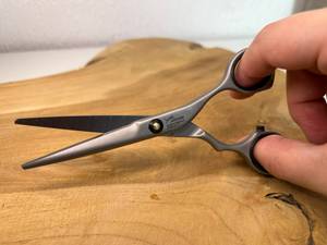 Eine Friseurschere muss fachgerecht gehalten werden.